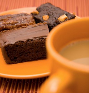 A Plate Of Chocolate Brownies And A Cup Of Coffee